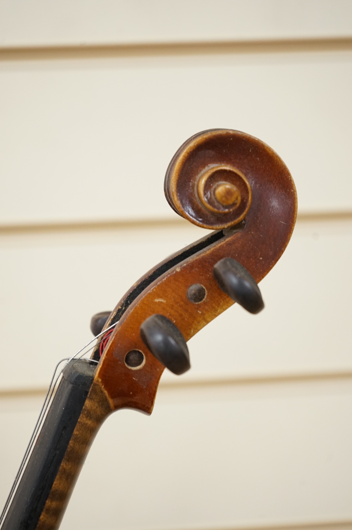 Five cased 20th century violins, including; a German violin, two Czech violins, a three-quarter size violin with a label for Bienfait, and a Romanian quarter size violin, all in cases or the remains of cases.